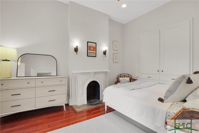 bedroom with dark hardwood / wood-style floors