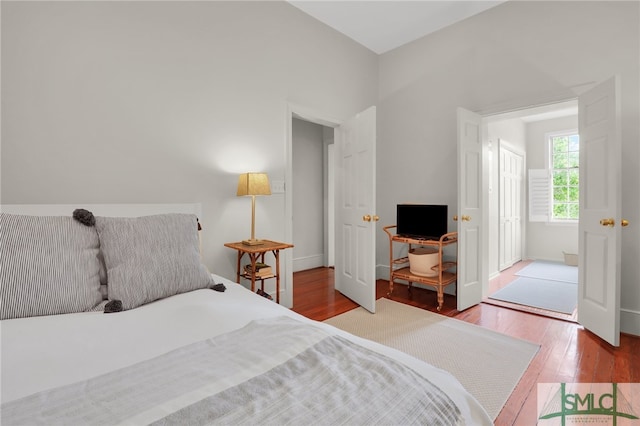 bedroom with hardwood / wood-style floors