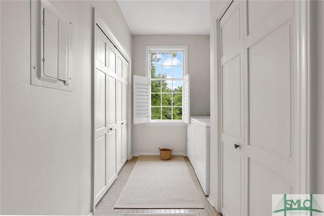 washroom with separate washer and dryer, electric panel, and light tile patterned flooring