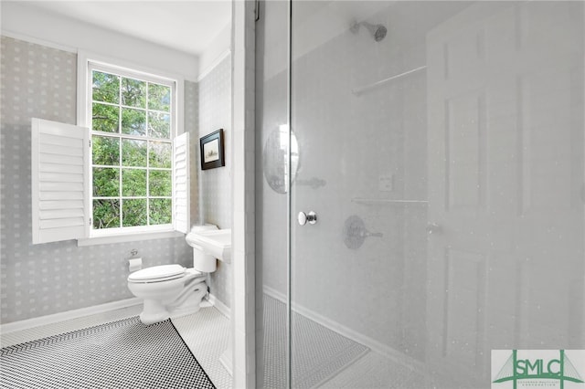 bathroom featuring toilet and tiled shower