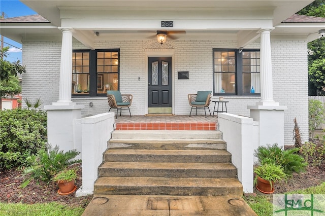 view of exterior entry with covered porch