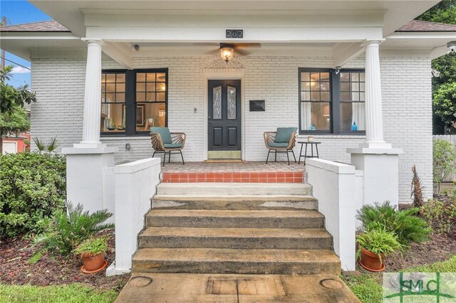 202 E 51st St, Savannah, GA 31405 - property entrance with a porch, brick siding, and a shingled roof