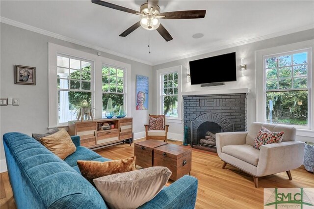 202 E 51st St, Savannah, GA 31405 - living area featuring healthy amount of natural light, crown molding, wood finished floors, ceiling fan, and a fireplace
