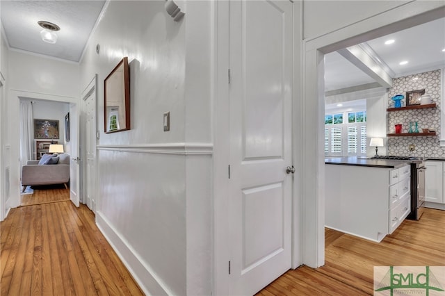 hall featuring crown molding and light wood-type flooring