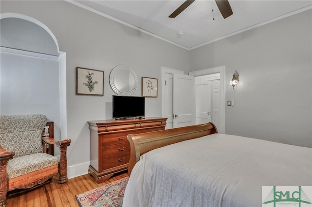 bedroom featuring crown molding, hardwood / wood-style flooring, and ceiling fan