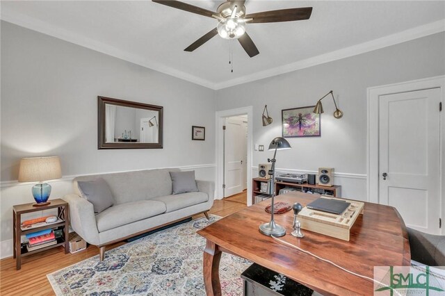 home office featuring ceiling fan, light hardwood / wood-style floors, and ornamental molding