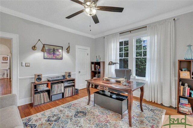 office featuring ceiling fan, ornamental molding, and light wood-type flooring