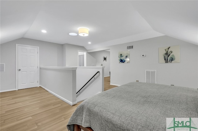 bedroom with hardwood / wood-style flooring and vaulted ceiling