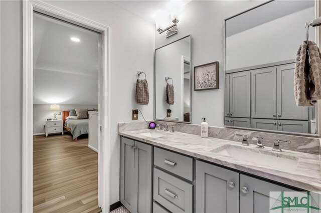 202 E 51st St, Savannah, GA 31405 - ensuite bathroom featuring double vanity, wood finished floors, and baseboards