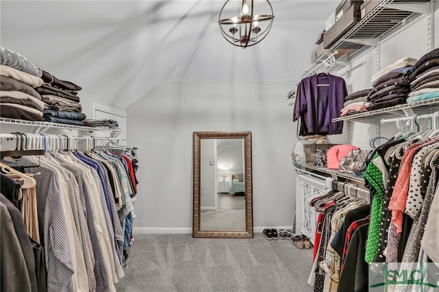 spacious closet with light carpet and vaulted ceiling