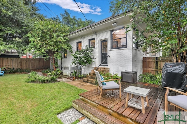 wooden terrace with grilling area and a lawn