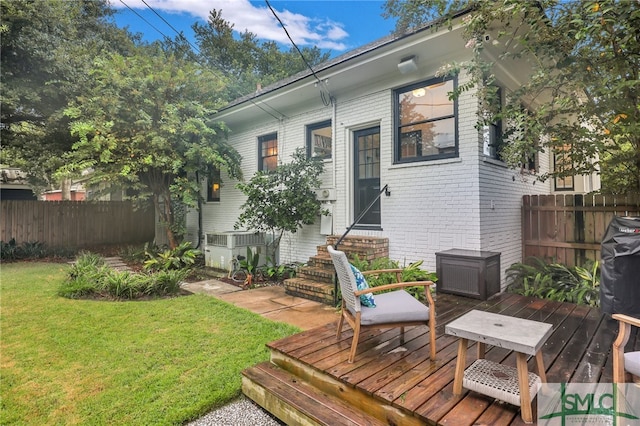 deck featuring a yard and cooling unit