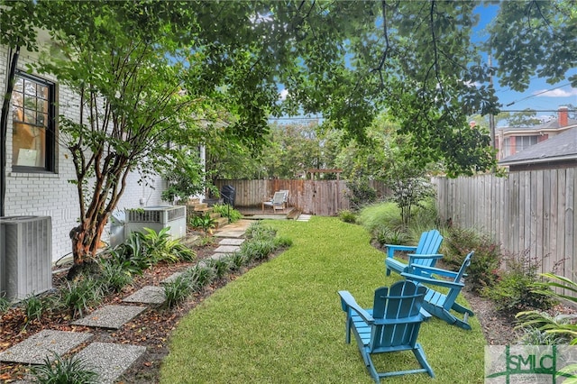 view of yard featuring central AC unit and a patio area