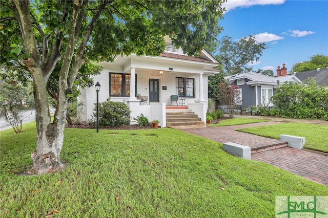 view of front of property with a front lawn and a porch