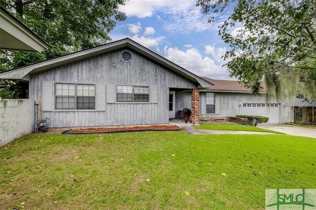 ranch-style home with a garage and a front lawn