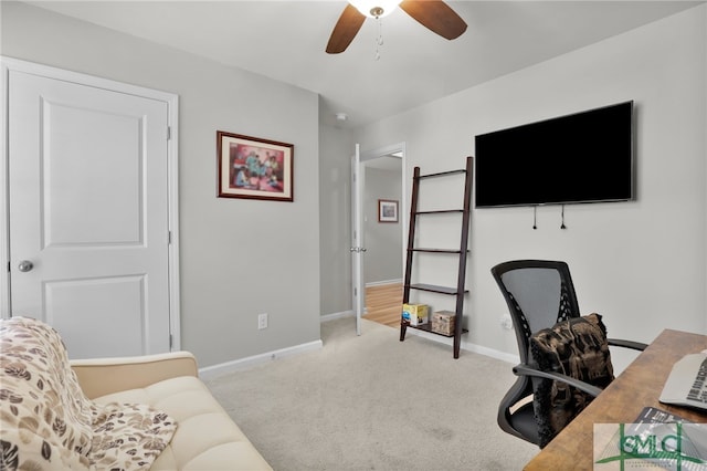 carpeted office space featuring ceiling fan