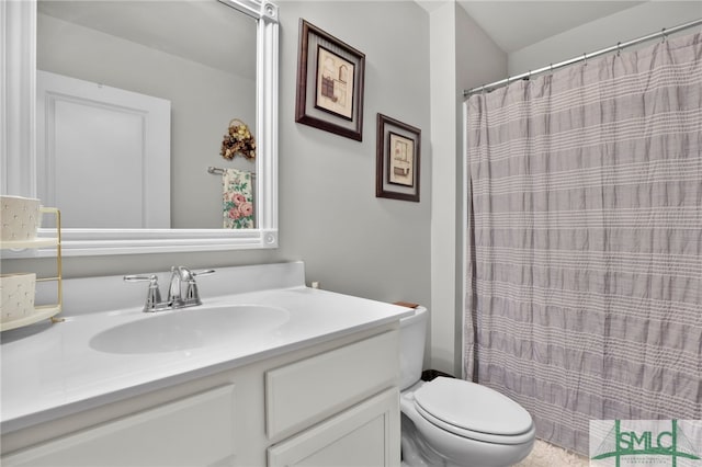 bathroom featuring vanity, toilet, and walk in shower