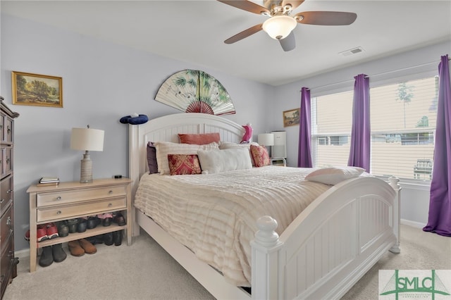 carpeted bedroom featuring ceiling fan and multiple windows