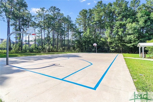 view of sport court with a yard