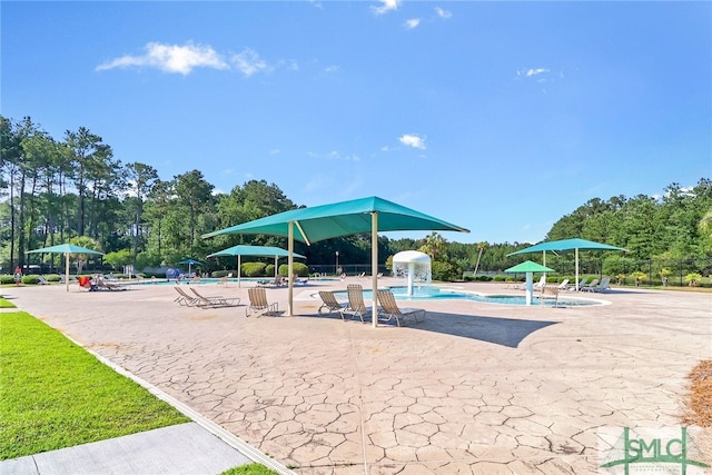 exterior space featuring pool water feature and a patio