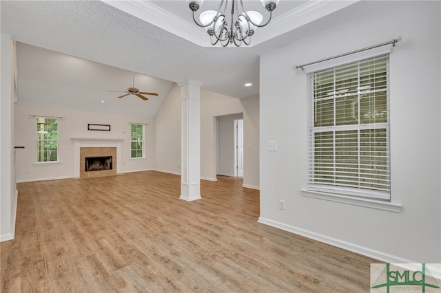 unfurnished living room with ceiling fan with notable chandelier, vaulted ceiling, a textured ceiling, and light hardwood / wood-style floors