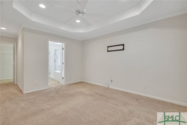 interior space featuring light colored carpet, crown molding, and ensuite bath