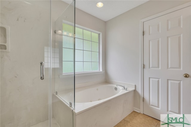 bathroom with tile patterned floors and plus walk in shower