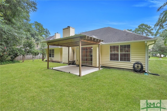 rear view of property with a patio area and a lawn