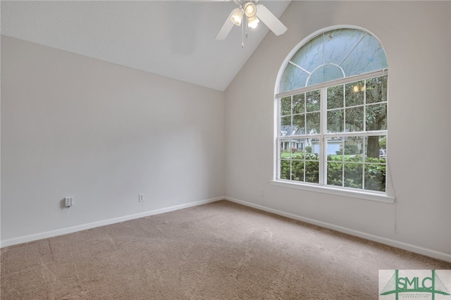 carpeted spare room with vaulted ceiling and ceiling fan