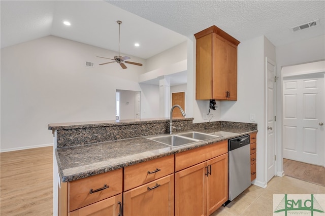 kitchen featuring dishwasher, light hardwood / wood-style flooring, sink, ceiling fan, and a textured ceiling