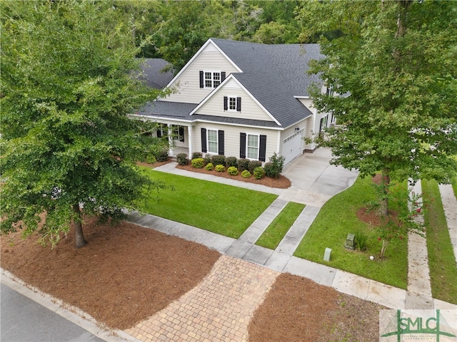 craftsman inspired home with a garage and a front lawn