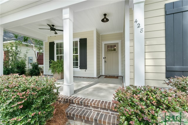 doorway to property featuring covered porch and ceiling fan