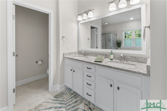 bathroom featuring vanity, toilet, and an enclosed shower