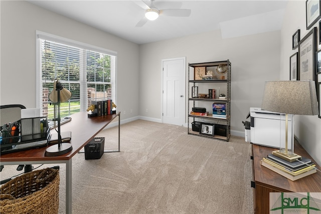 carpeted office space featuring ceiling fan