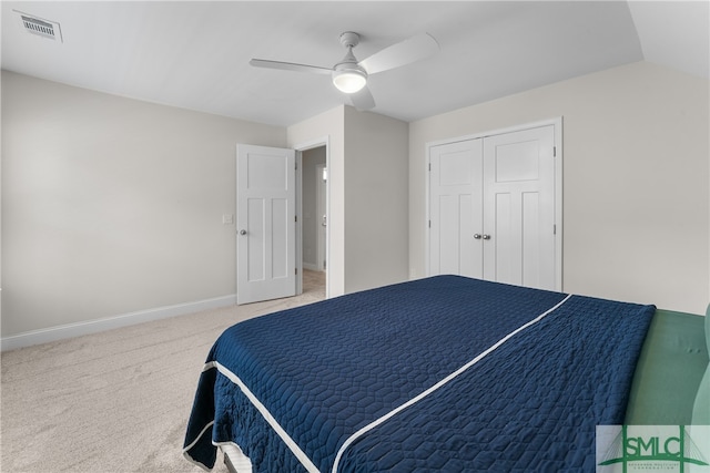 bedroom featuring vaulted ceiling, a closet, ceiling fan, and carpet flooring