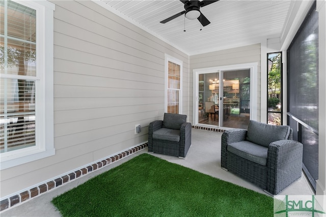 sunroom featuring ceiling fan