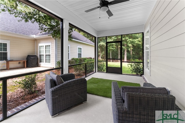 sunroom with wooden ceiling and ceiling fan