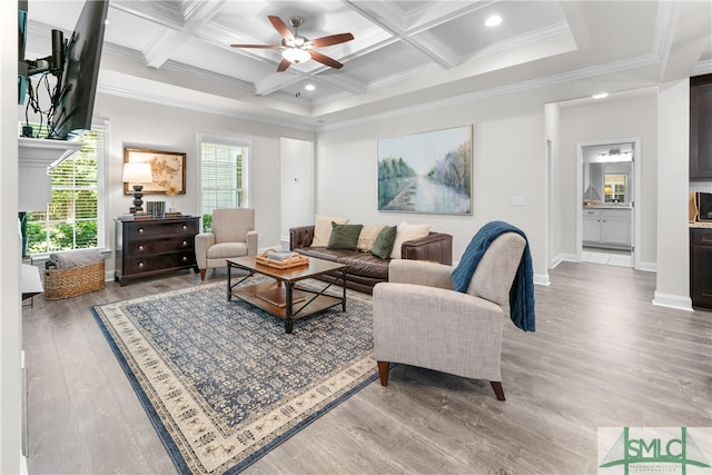 living room featuring light hardwood / wood-style flooring, ceiling fan, coffered ceiling, and beamed ceiling