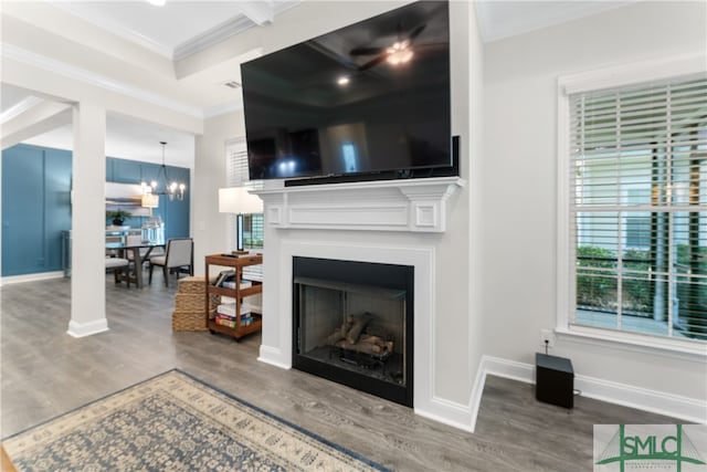 living room featuring hardwood / wood-style floors, a notable chandelier, and ornamental molding