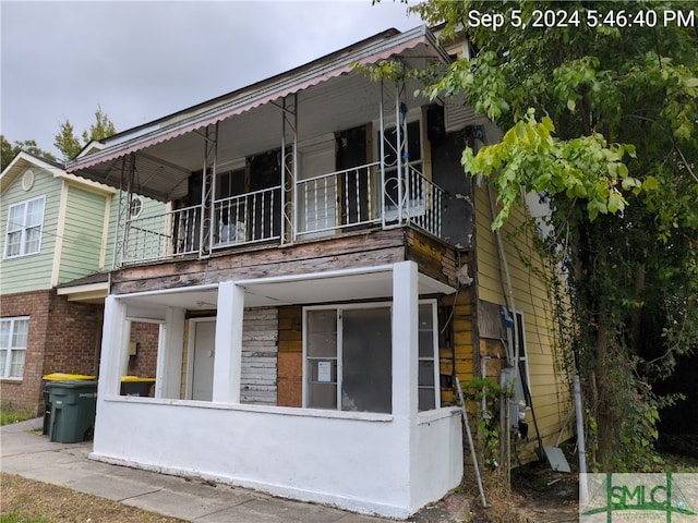 rear view of house featuring a balcony