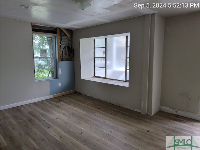 unfurnished room with wood-type flooring