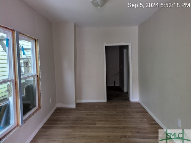 empty room with dark wood-type flooring