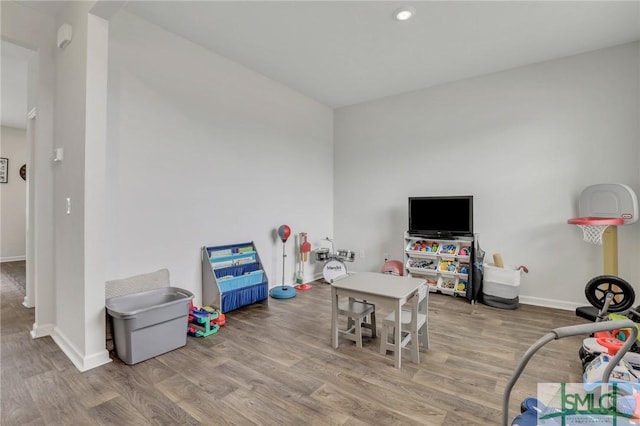 playroom with baseboards and wood finished floors