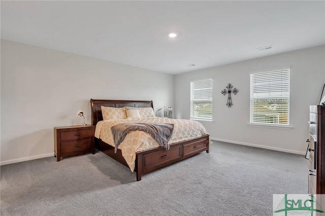 bedroom featuring visible vents, baseboards, and light carpet