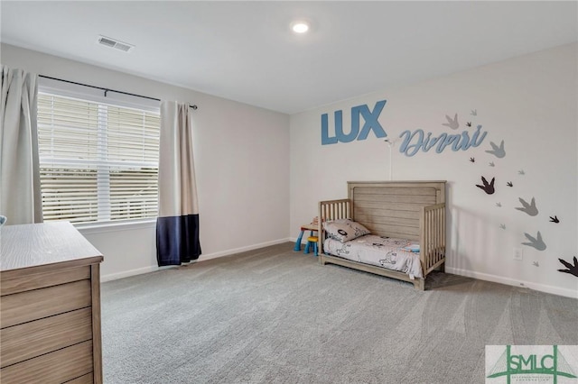 carpeted bedroom featuring visible vents and baseboards