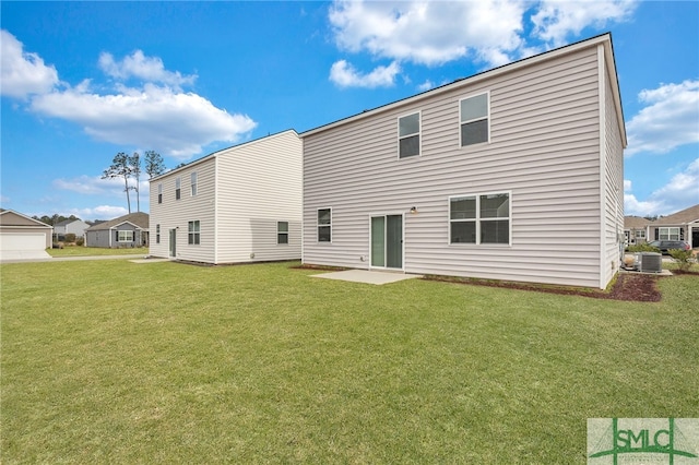 rear view of house with cooling unit, a patio, and a lawn