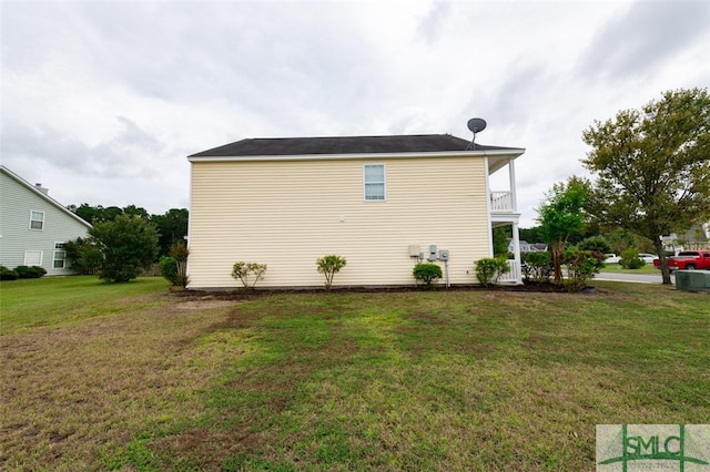 view of property exterior with a balcony and a yard