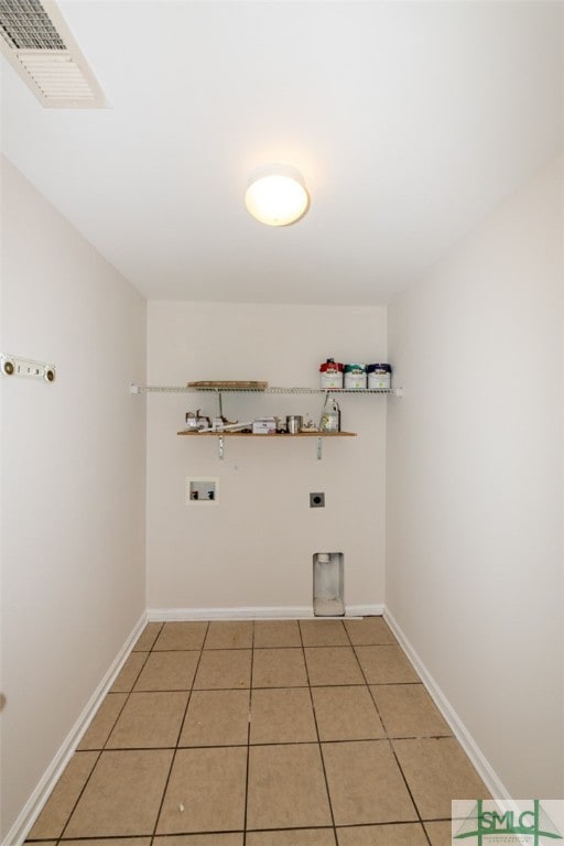 washroom featuring hookup for a gas dryer, hookup for an electric dryer, hookup for a washing machine, and tile patterned floors