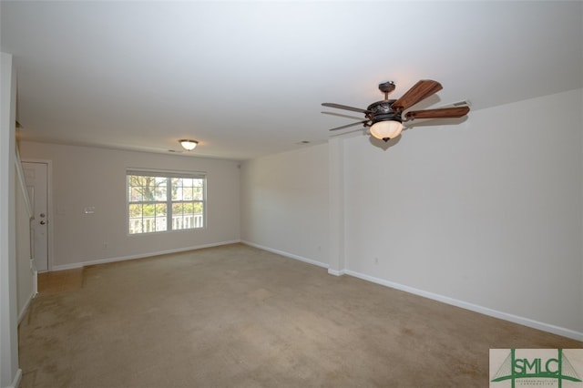 carpeted spare room featuring ceiling fan