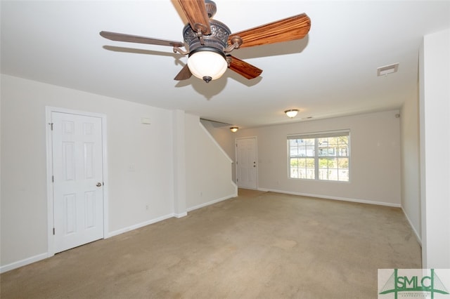 carpeted spare room with ceiling fan